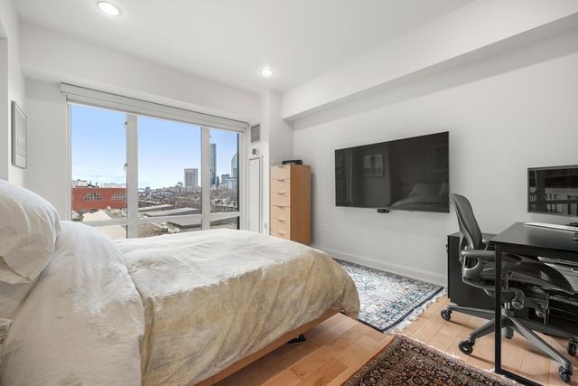 a bedroom with a bed a desk and chair