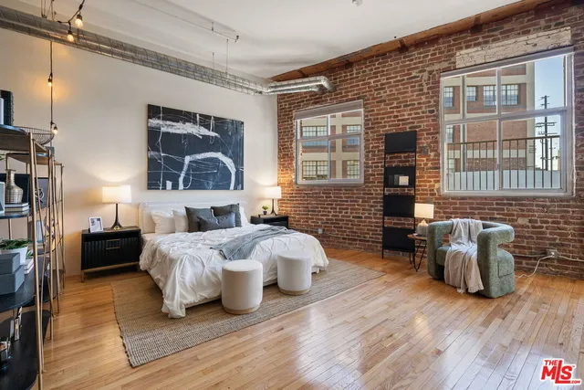 a bedroom with furniture and a wooden floor