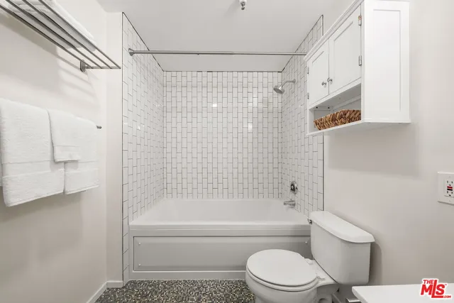 a view of a patio with a table and chairs and potted plants