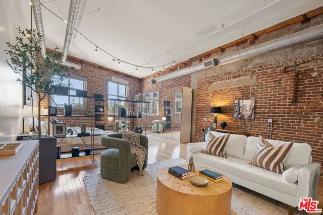 a view of a livingroom with furniture and a potted plant