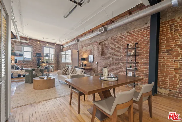 a dining room with furniture and wooden floor