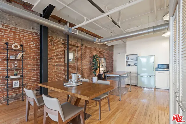 a dining room with furniture and wooden floor