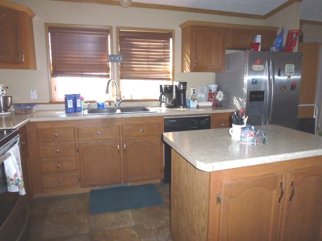 6009 Park Road Clinton, IL 61727 - Photo 13 of 15 a kitchen with sink cabinets and window