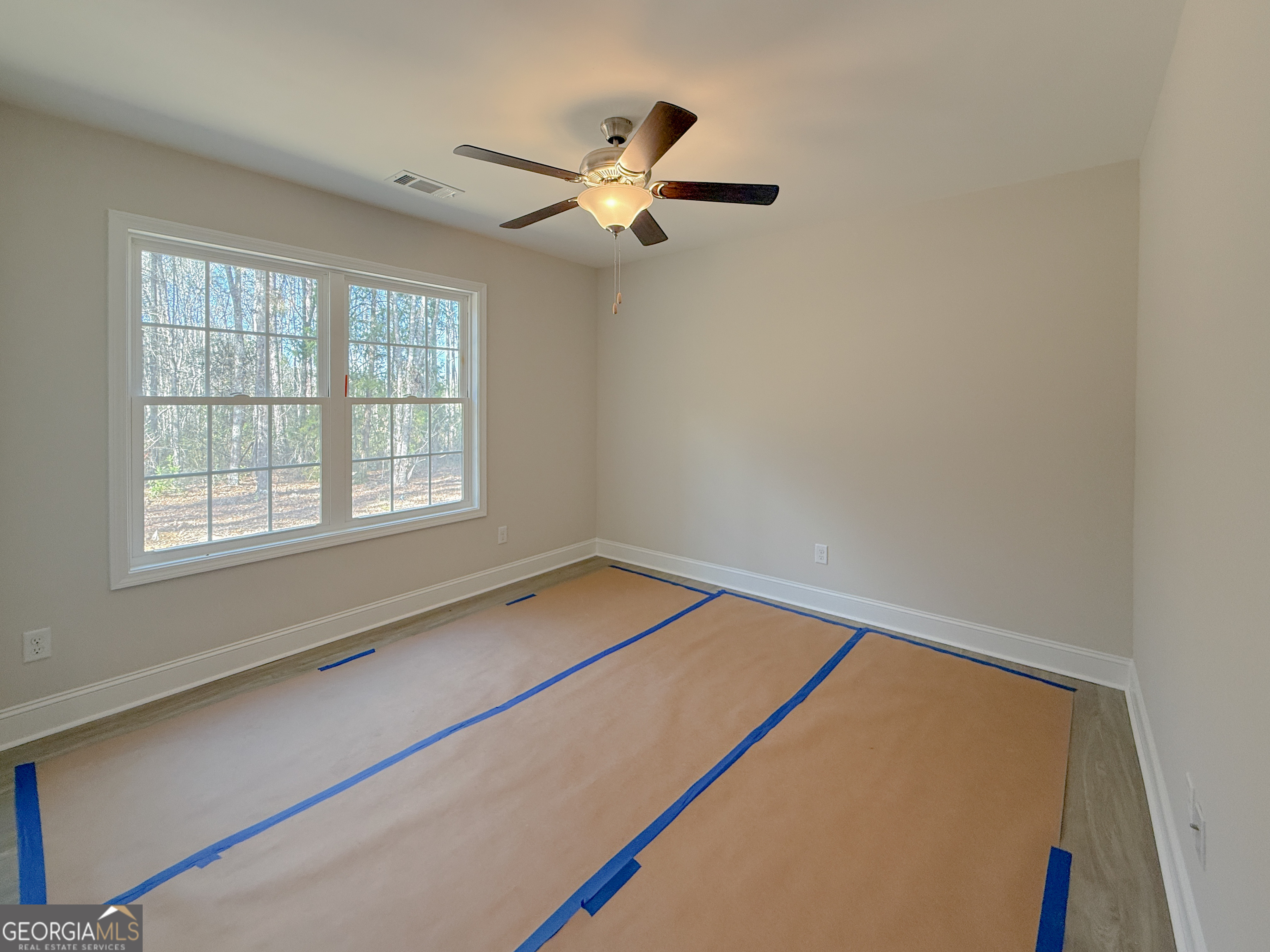 3156 Sterling Road Claxton, GA 30417 - Photo 16 of 22 a view of a room with a ceiling fan and a window