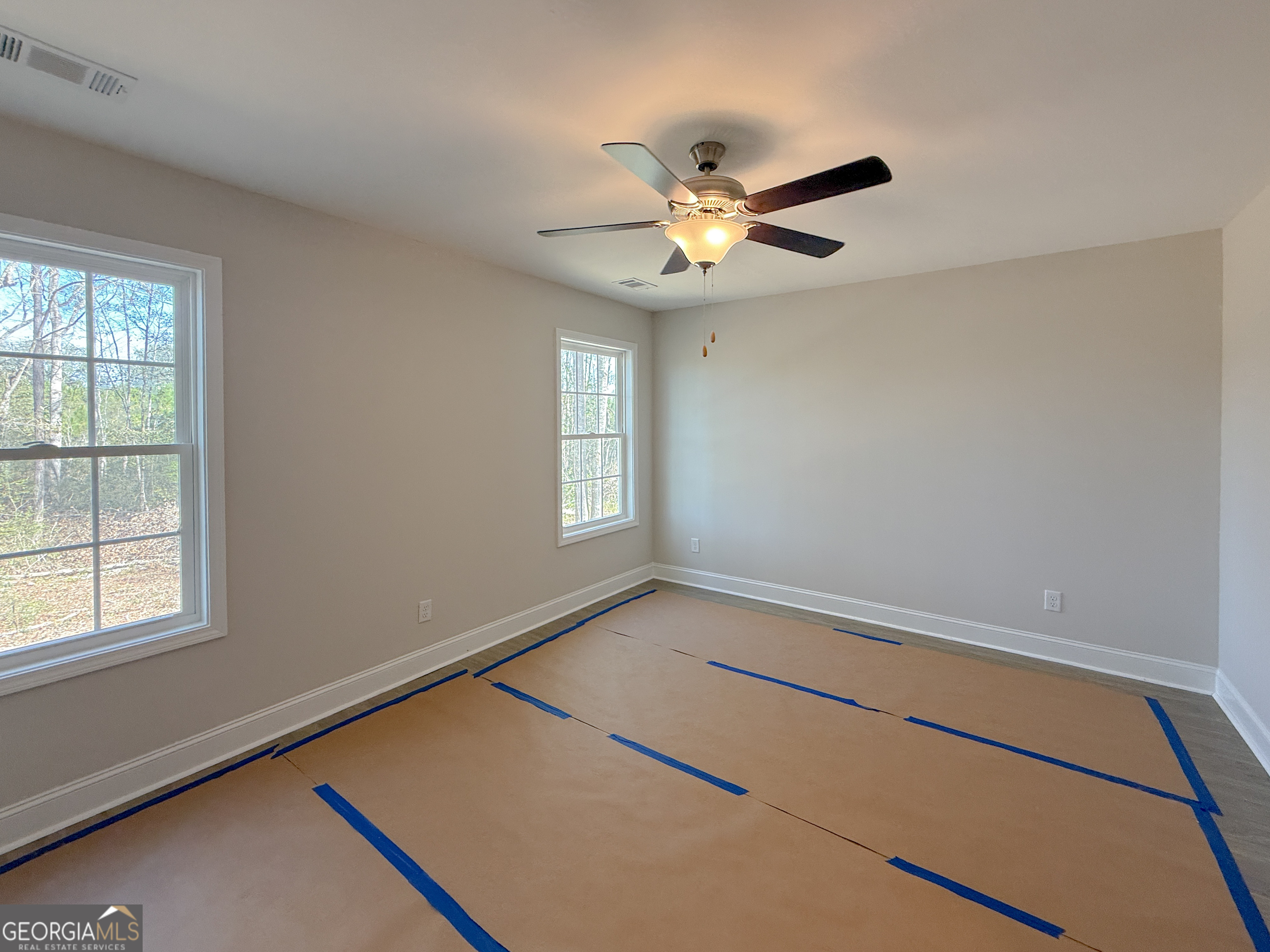 3156 Sterling Road Claxton, GA 30417 - Photo 20 of 22 an empty room with windows and fan