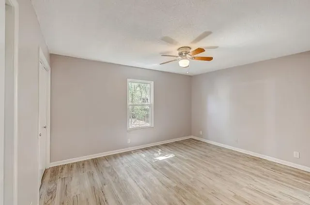 wooden floor in an empty room with a window