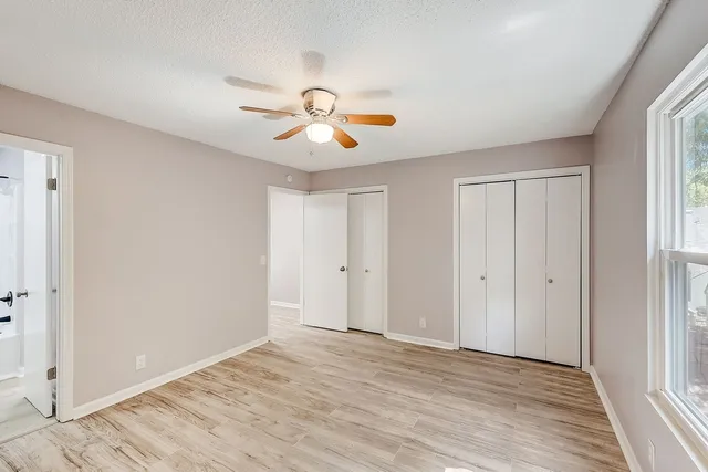 a view of room with a ceiling fan and window