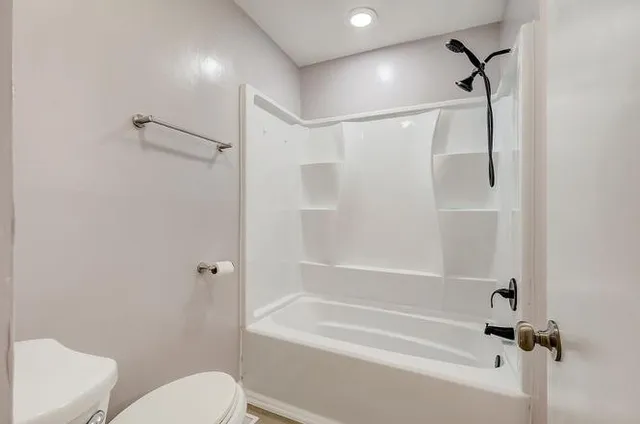 a bathroom with a shower and a toilet