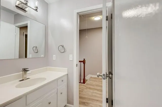a en suite bathroom with a sink and mirror