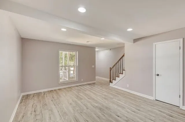 a view of an entryway with wooden floor