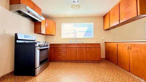 a kitchen with stainless steel appliances a refrigerator and a stove