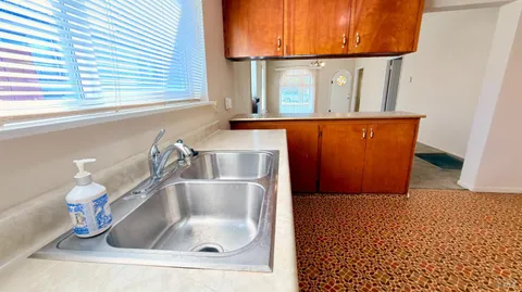 a kitchen with wooden cabinets and a stove top oven
