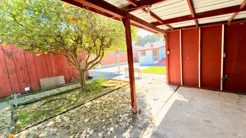 a front view of house with yard and trees around