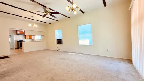 a view of a kitchen with a sink and refrigerator