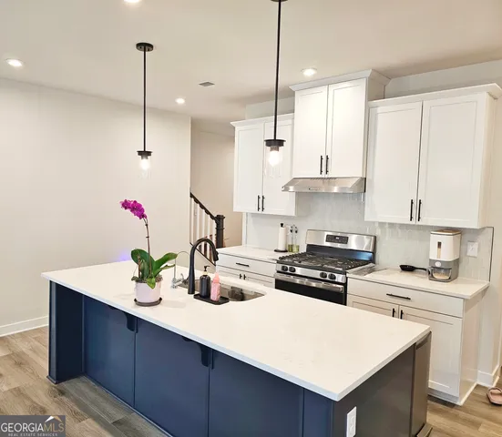 a room with a sink a bed and a chandelier