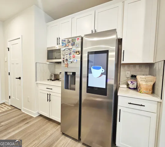 a kitchen with stainless steel appliances kitchen island granite countertop a sink and a stove