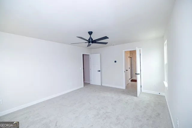 a spacious bathroom with a double vanity sink a mirror and a shower