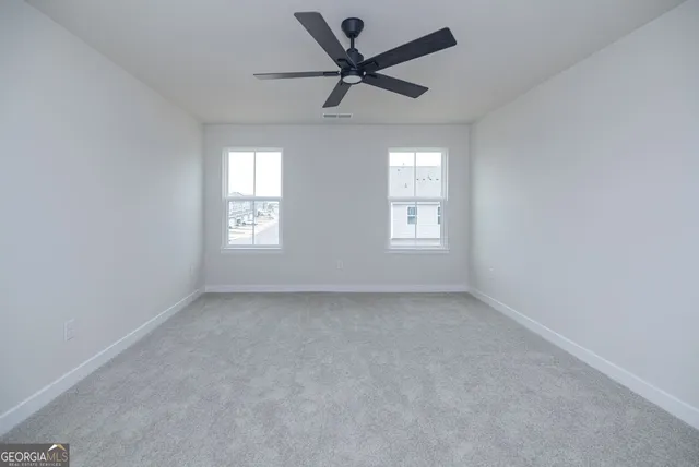 a spacious bathroom with a double vanity sink and mirror with shower