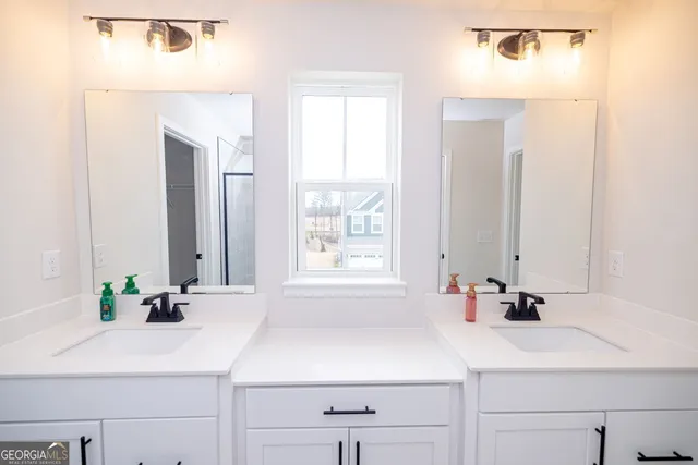 a view of washer and dryer with kitchen in the background