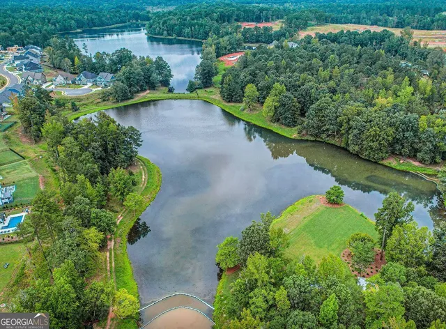 a view of a swimming pool with a yard and sitting area