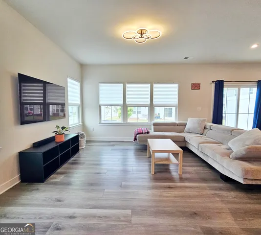 a view of a dining room with furniture and wooden floor