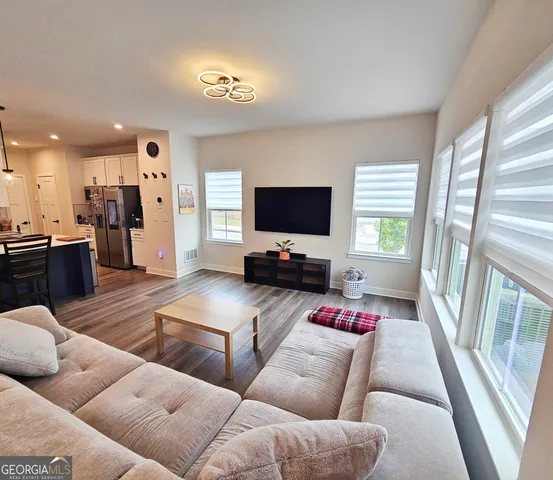 a view of a dining room with furniture and wooden floor