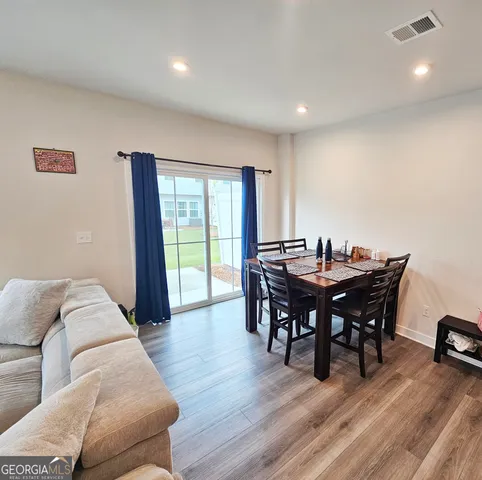 a living room with furniture and large windows