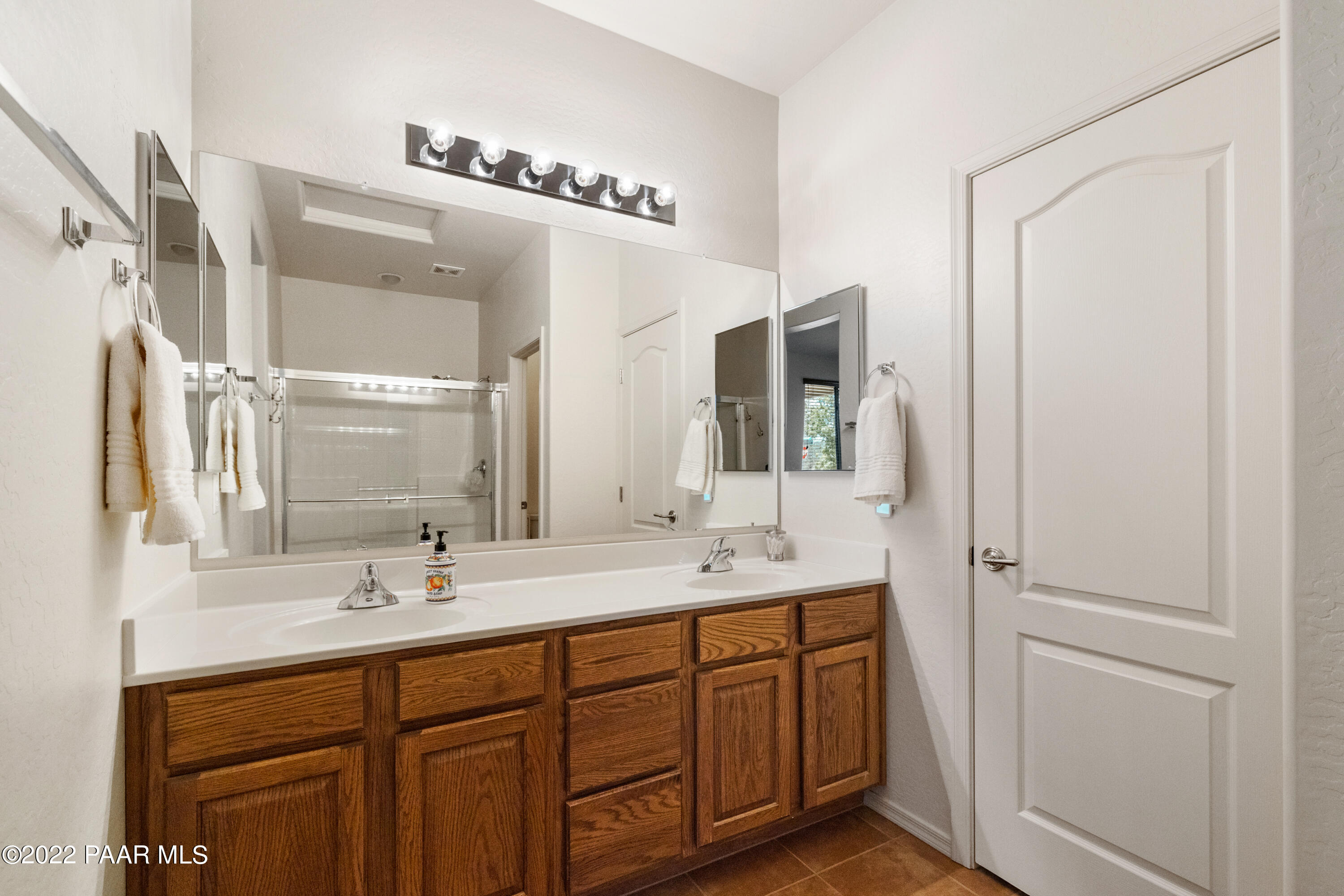 7226 Woolsey Ranch Road Prescott Valley, AZ 86314 - Photo 15 of 30 a bathroom with a double vanity sink and mirror