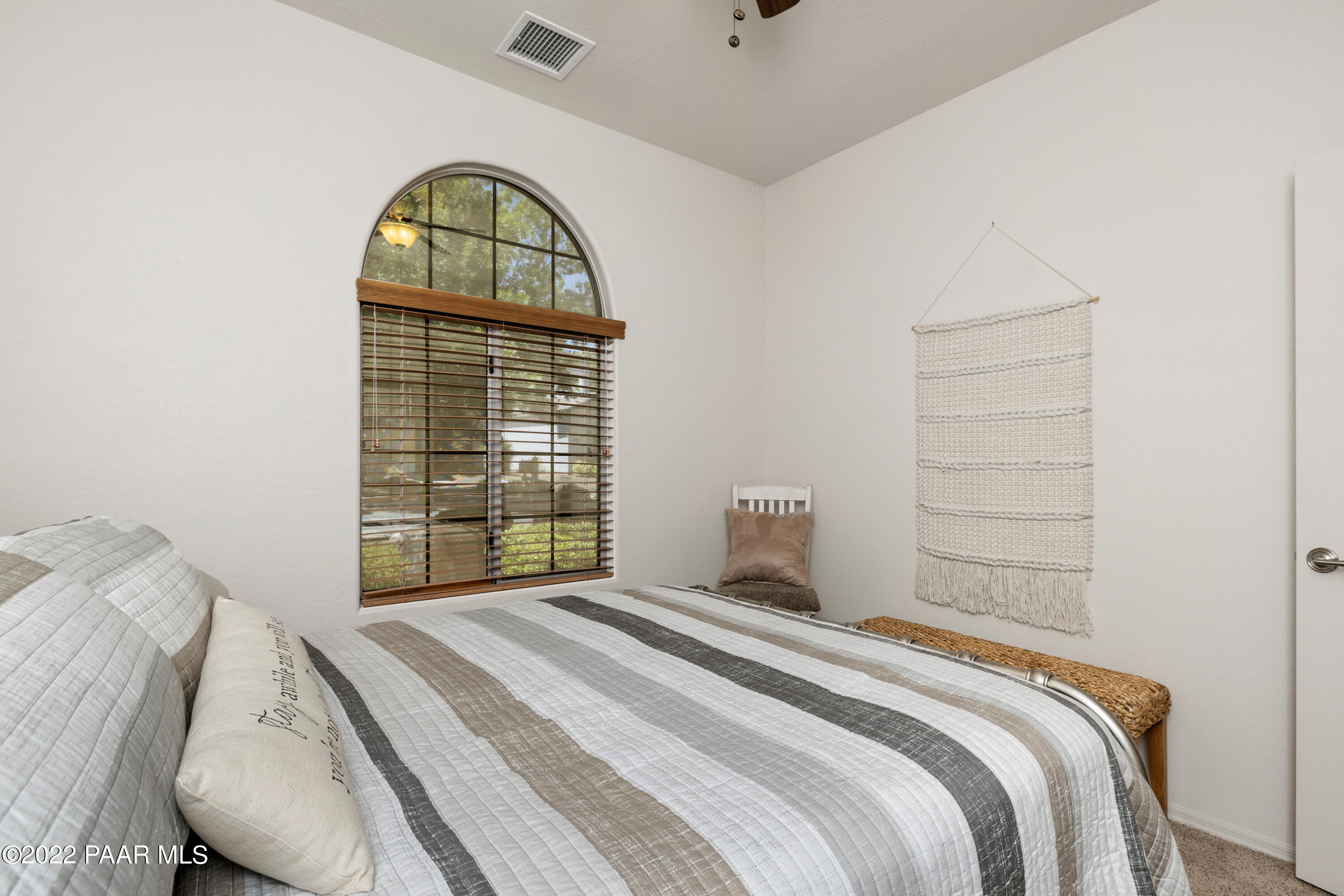 7226 Woolsey Ranch Road Prescott Valley, AZ 86314 - Photo 18 of 30 a bedroom with a bed and a window