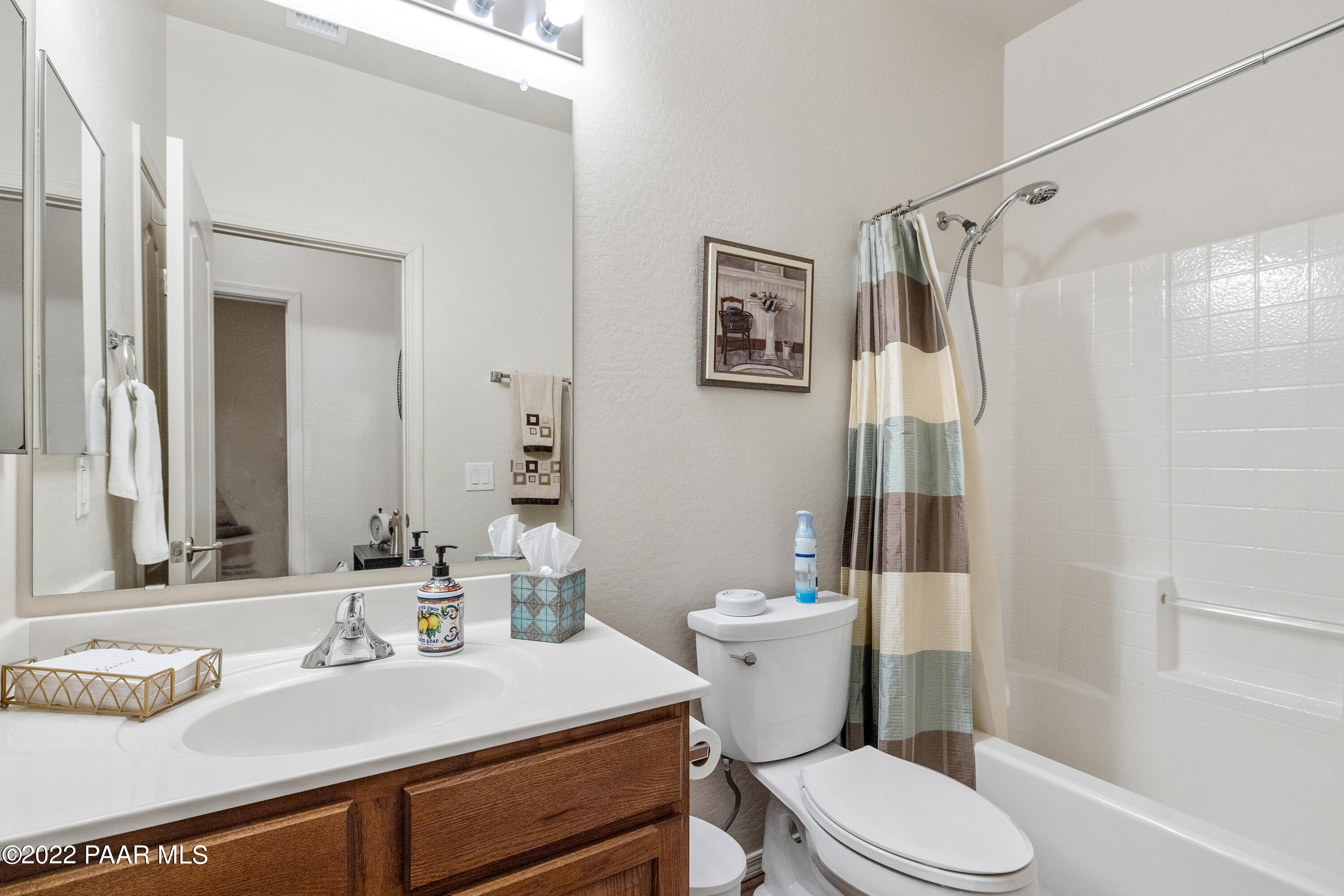 7226 Woolsey Ranch Road Prescott Valley, AZ 86314 - Photo 19 of 30 a bathroom with a sink toilet vanity and shower