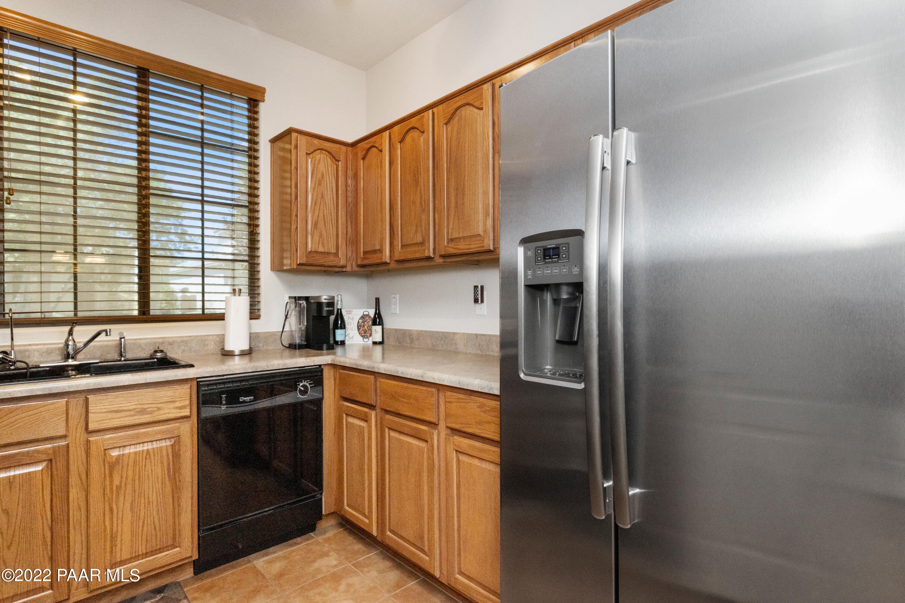7226 Woolsey Ranch Road Prescott Valley, AZ 86314 - Photo 9 of 30 a kitchen with stainless steel appliances granite countertop a refrigerator and a sink