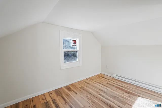a view of a room with wooden floor and closet