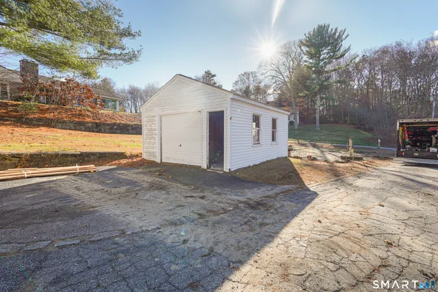 a view of a house with backyard and trees