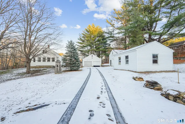 a white house with trees in front of it