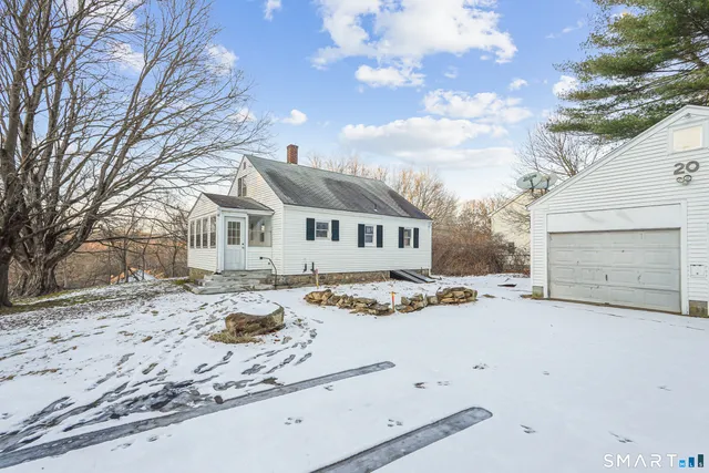 a view of a house with snow on the road
