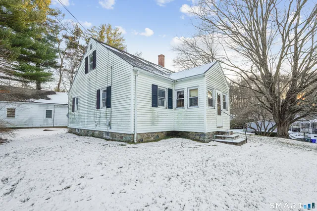 a view of a house with a snow in the yard
