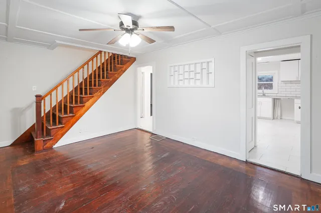 a view of an entryway with wooden floor