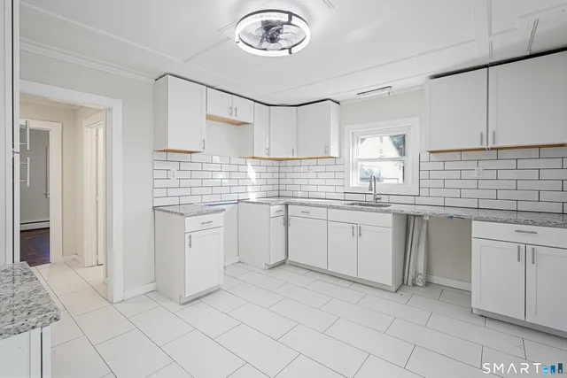 a kitchen with cabinets and window