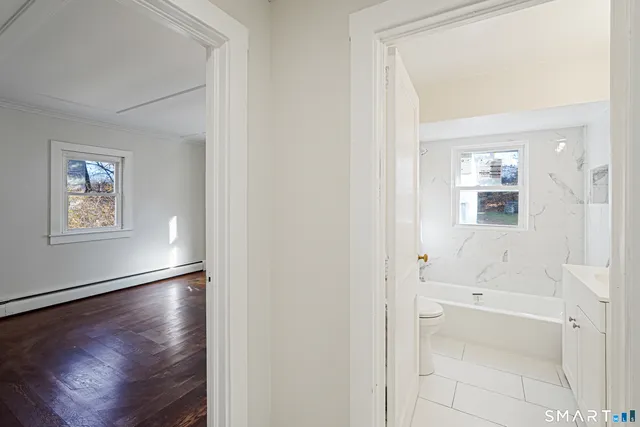 a view of a hallway with wooden floor
