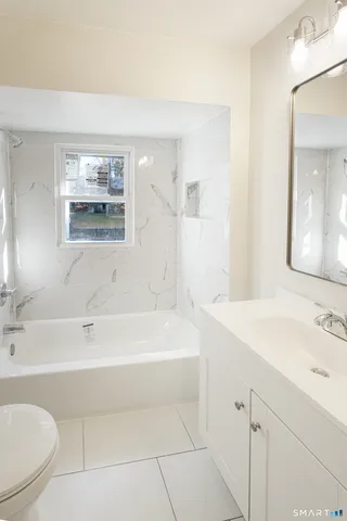 a bathroom with a sink a toilet and a bathtub
