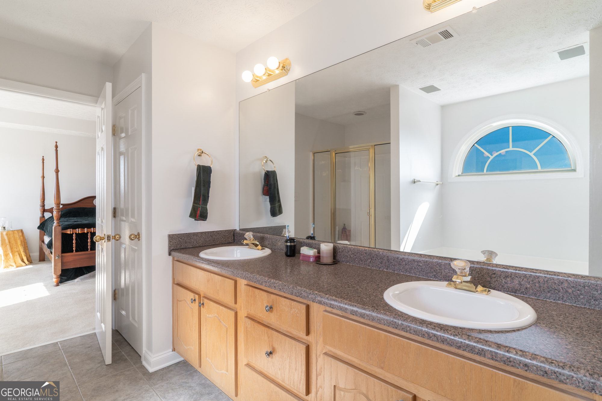 724 Teamon Road Griffin, GA 30223 - Photo 41 of 50 a bathroom with a double vanity sink and a mirror