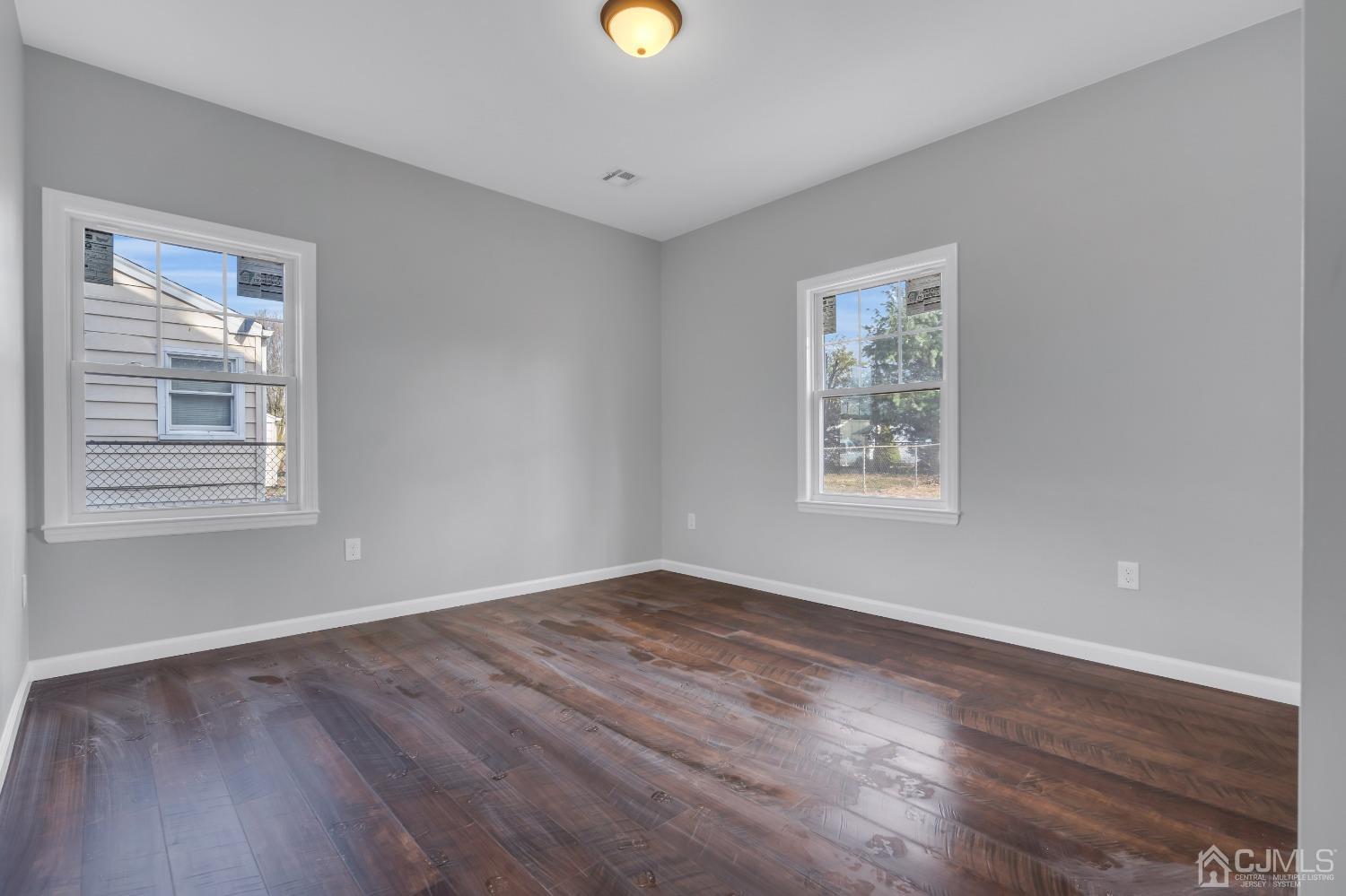 12 Fairfax Road Edison, NJ 08817 - Photo 16 of 30 a view of an empty room with wooden floor and a window