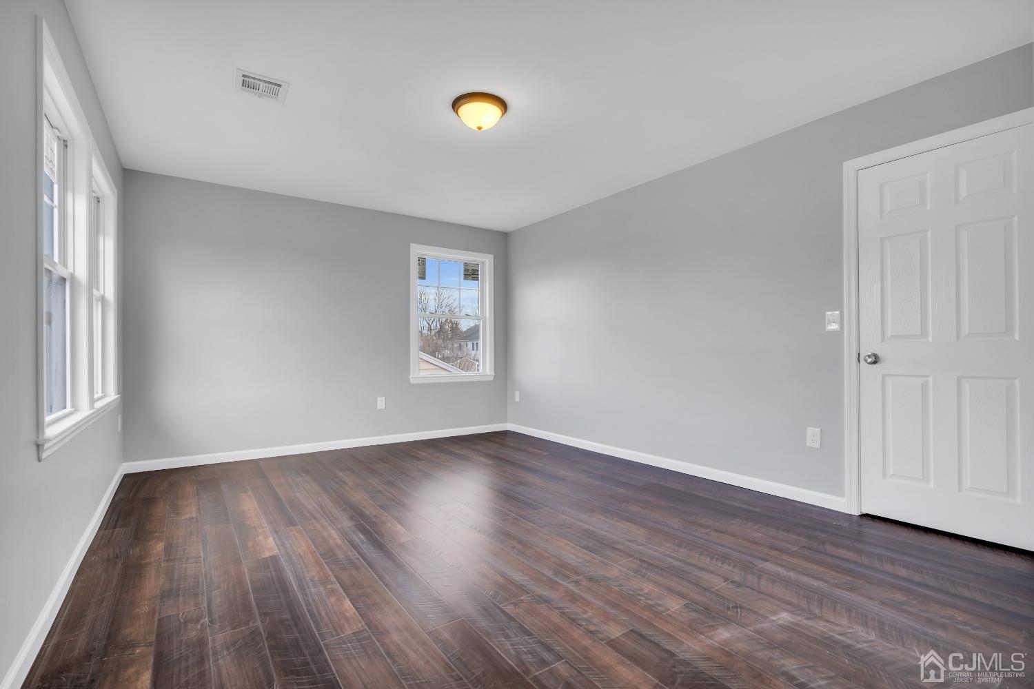 12 Fairfax Road Edison, NJ 08817 - Photo 19 of 30 an empty room with wooden floor and windows
