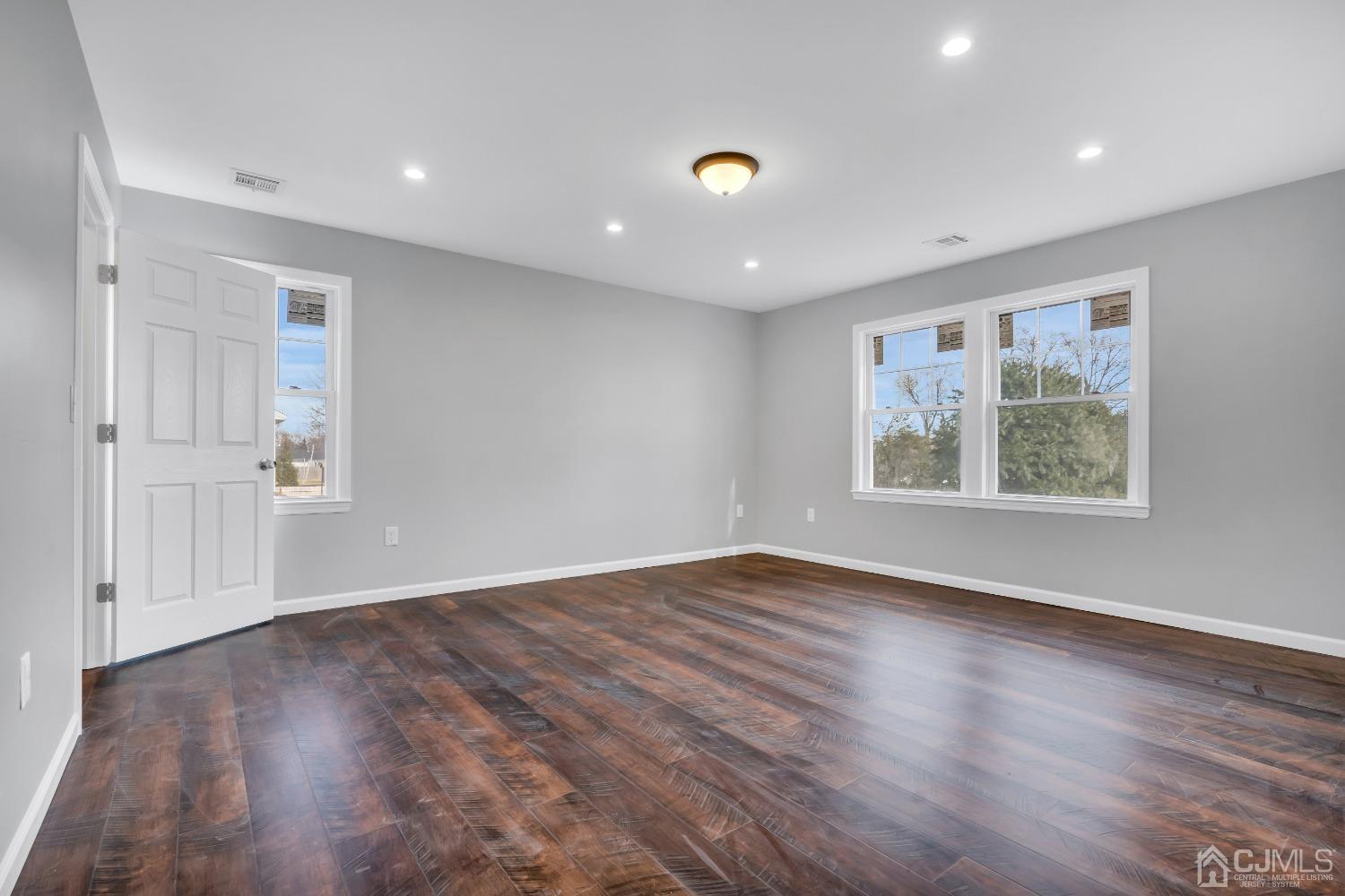 12 Fairfax Road Edison, NJ 08817 - Photo 20 of 30 an empty room with wooden floor and window
