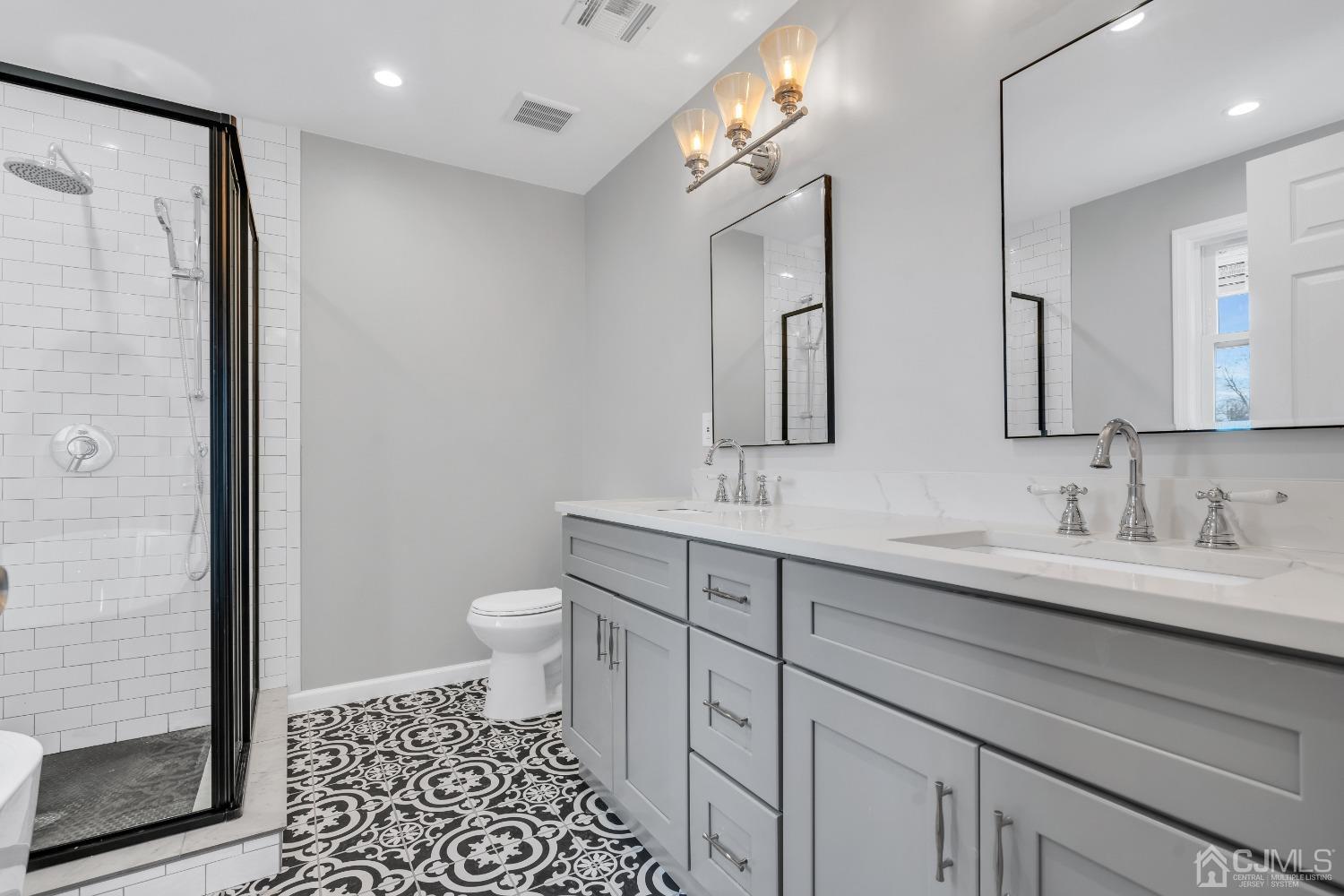 12 Fairfax Road Edison, NJ 08817 - Photo 23 of 30 a bathroom with a double vanity sink toilet and shower