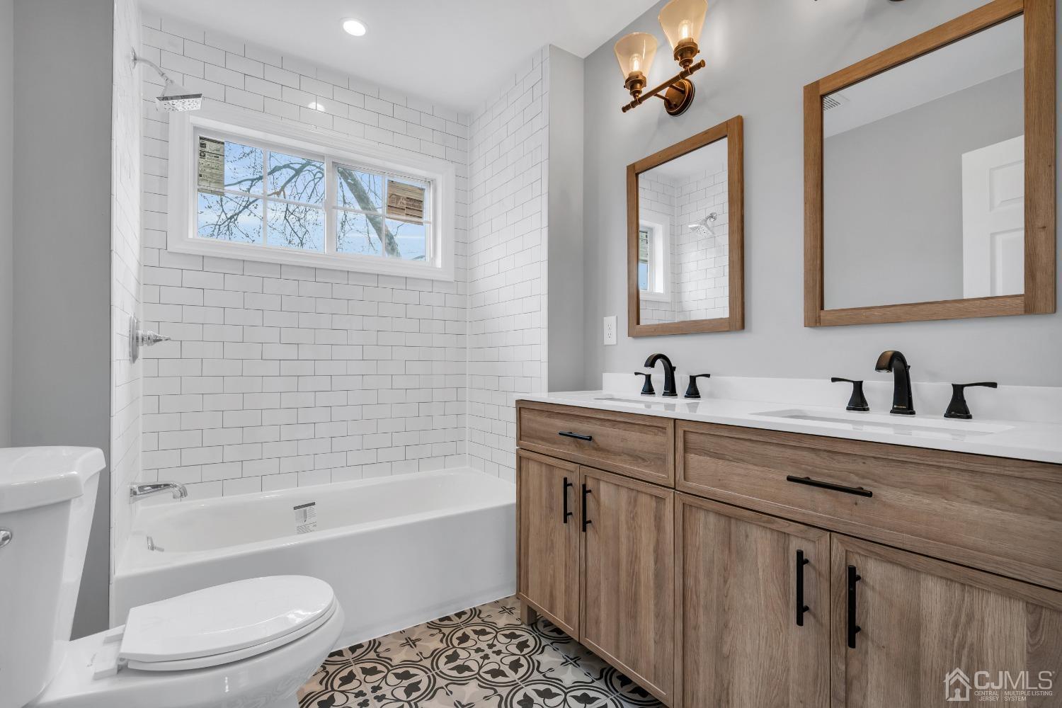 12 Fairfax Road Edison, NJ 08817 - Photo 25 of 30 a bathroom with a bathtub sink mirror vanity and toilet