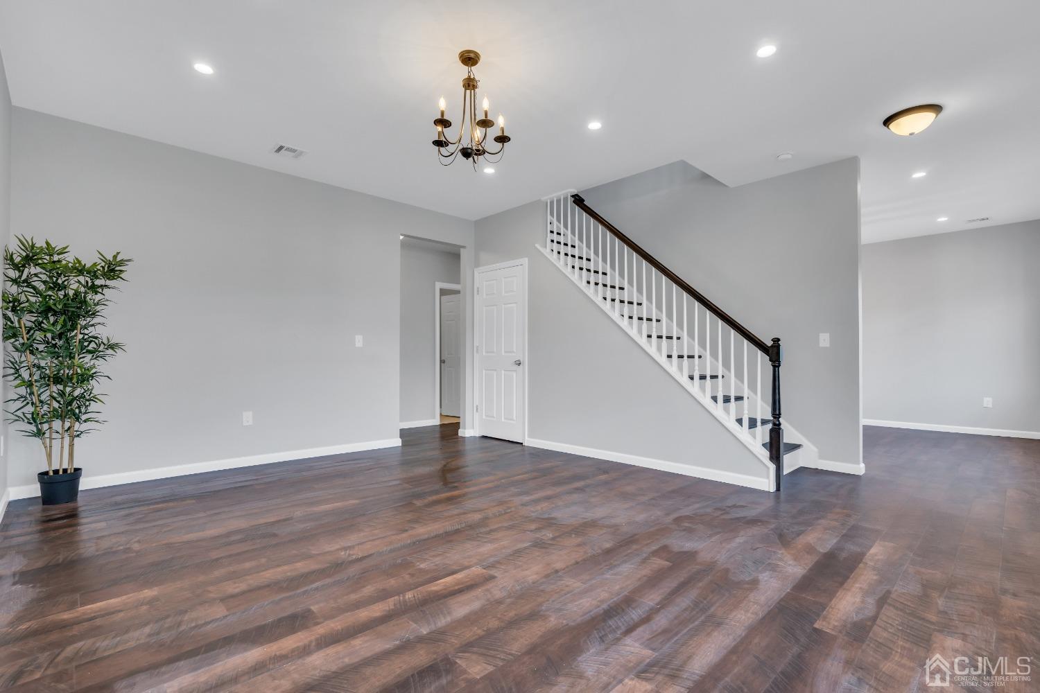 12 Fairfax Road Edison, NJ 08817 - Photo 6 of 30 a view of an empty room with wooden floor and potted plants