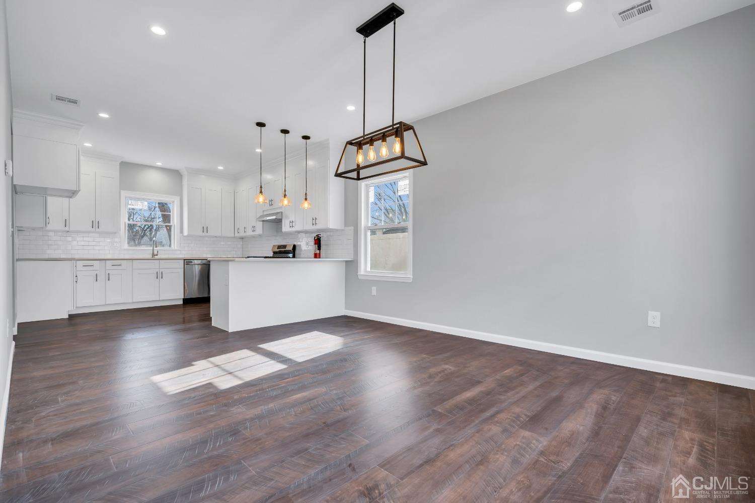 12 Fairfax Road Edison, NJ 08817 - Photo 7 of 30 a living room with kitchen island stainless steel appliances granite countertop furniture and a wooden floor