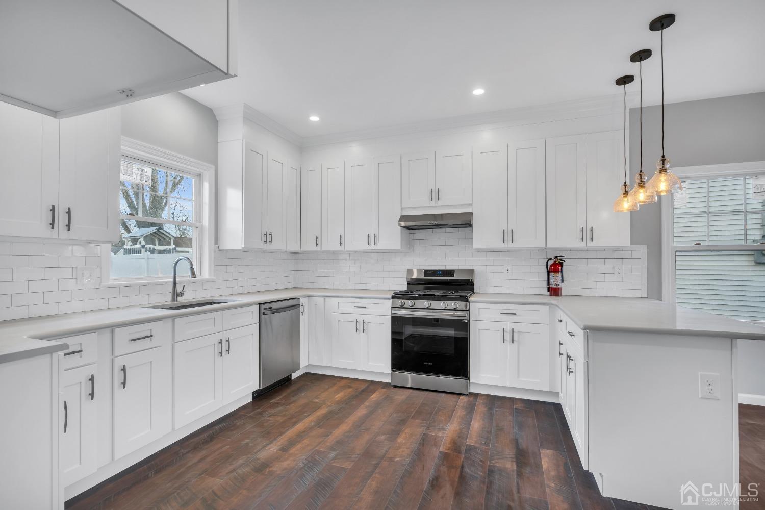 12 Fairfax Road Edison, NJ 08817 - Photo 9 of 30 a kitchen with granite countertop white cabinets and white appliances