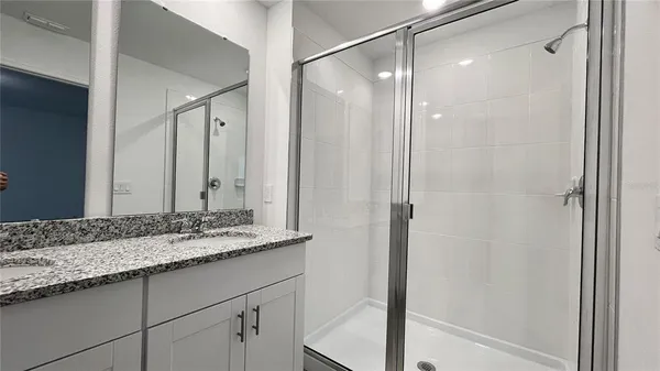 a bathroom with a granite countertop sink mirror and double